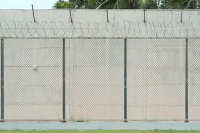 Metal fence against wall