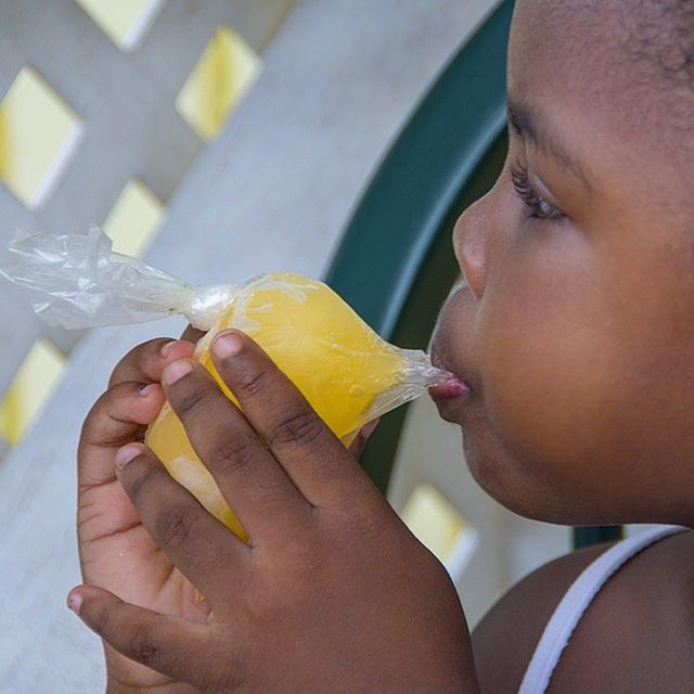 person, holding, lifestyles, indoors, cropped, leisure activity, part of, close-up, childhood, headshot, food and drink, focus on foreground, human finger, elementary age, boys