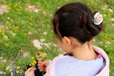 Close-up of young woman smelling flowers