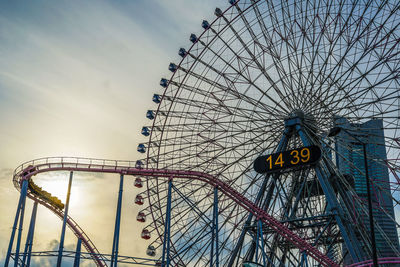 Low angle view of ferris wheel against sky