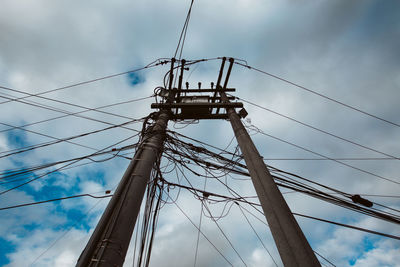 Low angle view of electricity pylon against sky