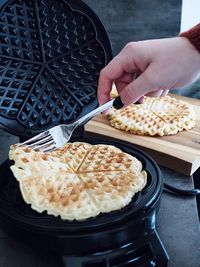 High angle view of hand holding food in kitchen