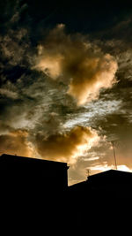 Low angle view of building against cloudy sky