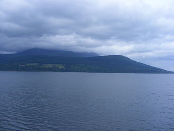 Scenic view of mountains against cloudy sky