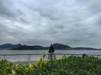 Scenic view of lake against cloudy sky