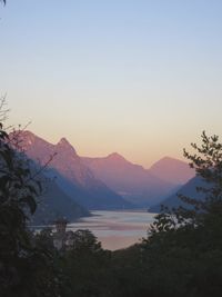 Scenic view of sea and mountains against sky