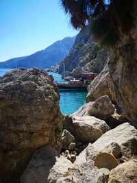 Scenic view of sea and mountains against sky
