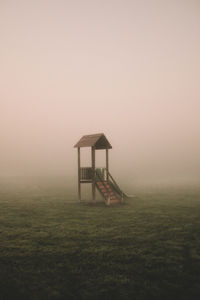 View of slide at playground against foggy background