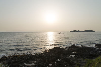 Scenic view of sea against clear sky during sunset