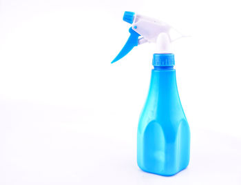 Close-up of blue glass bottle on white background