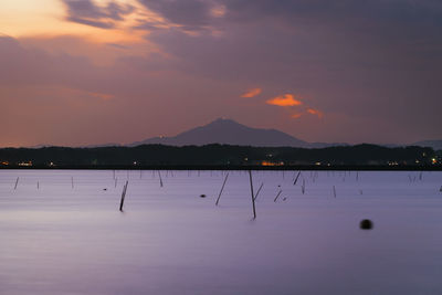 Scenic view of lake against sky during sunset