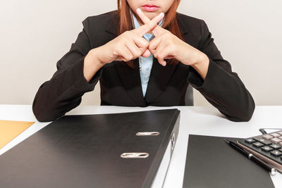 Low angle view of woman using smart phone on table