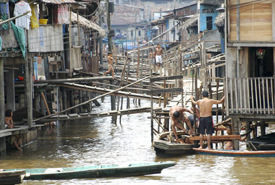 Boats in canal along buildings