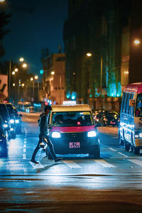 Cars on city street at night