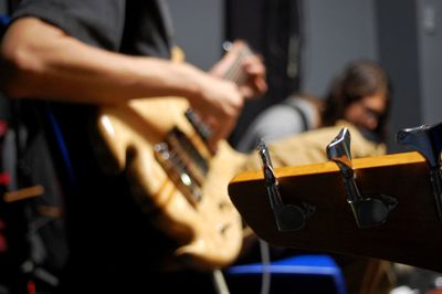 Cropped hand of musician playing guitar