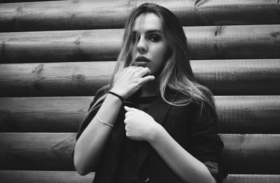 Portrait of young woman smoking outdoors