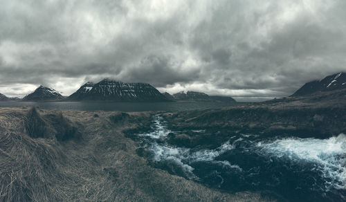 Panoramic view of sea and mountains against sky