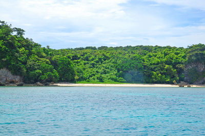 Scenic view of swimming pool by sea against sky