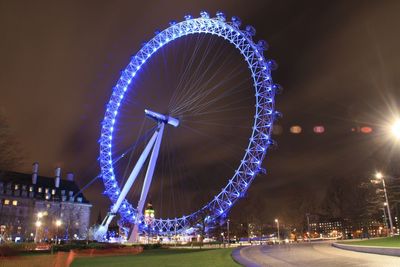 Low angle view of illuminated ferris wheel at night