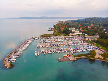 High angle view of marina and buildings against sky