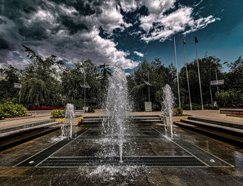 Fountain in park against sky