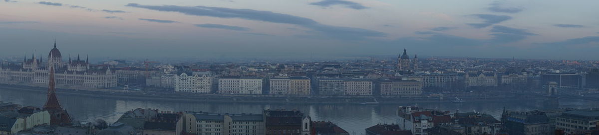 High angle view of buildings in town against sky at sunset