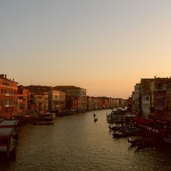 Boats in river with buildings in background