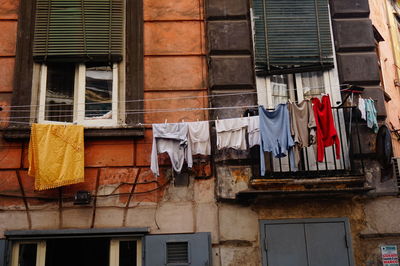 Low angle view of clothes drying against building