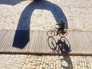 High angle view of man cycling on bicycle in city