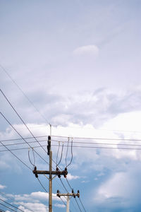 Low angle view of electricity pylon against sky