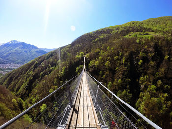 Dramatic tibetan bridge suspended 426 ft. above a forested mountain gorge with scenic views.