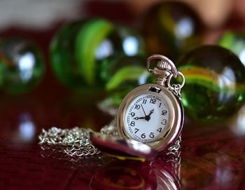 Close-up of pocket watch on table