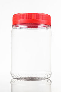 Close-up of empty glass jar against white background