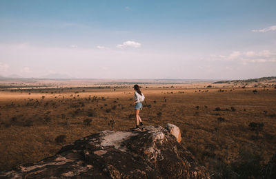 Full length side view of man standing on rock