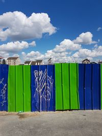 Multi colored wall against blue sky