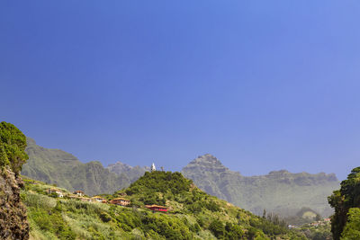 View of mountain range against blue sky