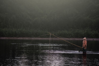 Person fishing in lake