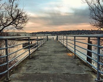 Bridge over river at sunset