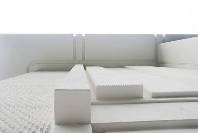 Close-up of white wooden table against wall at home