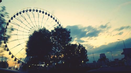 Low angle view of ferris wheel against sky