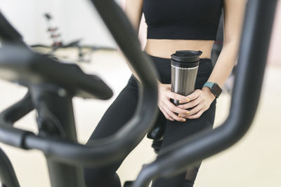 Close-up of woman holding bicycle