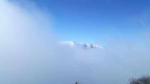 Low angle view of snowcapped mountain against sky