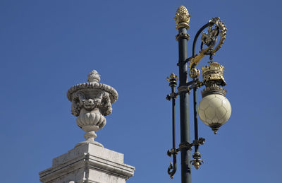 Low angle view of statue against clear blue sky