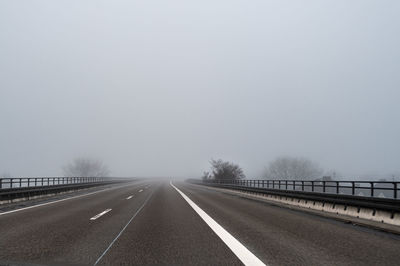 Empty road against clear sky