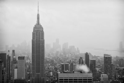 Empire state building against foggy background