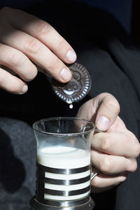 Close-up of hand pouring drink in glass