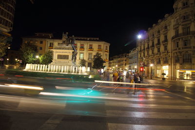 Illuminated city street at night