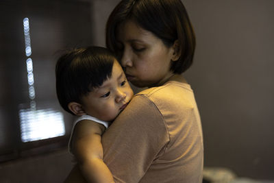 Side view of young woman at home