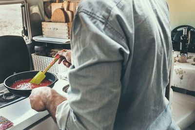 Midsection of man preparing food