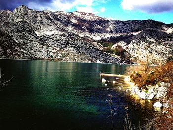 Scenic view of lake against cloudy sky